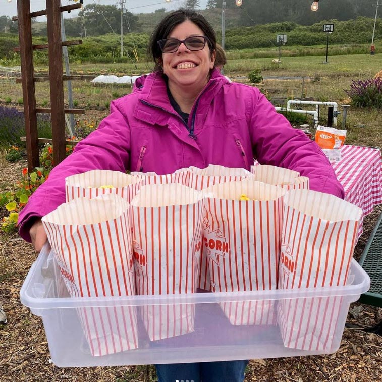 resident serving popcorn for outdoor movie night