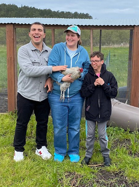 Big Wave residents at the Farm caring for chickens